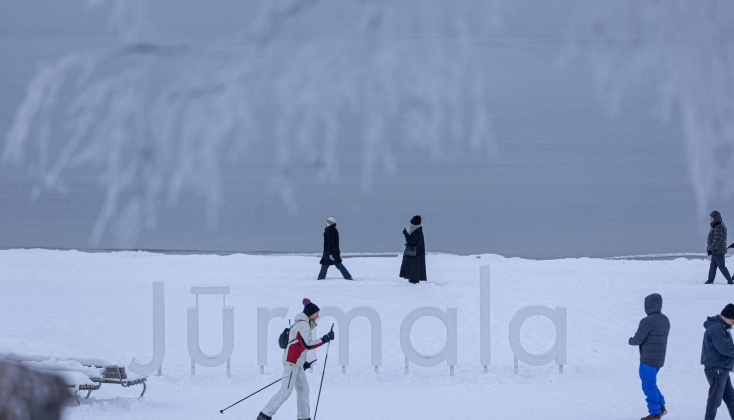 Ziema Jūrmalā, cilvēki pludmalē slēpo un pastaigājas